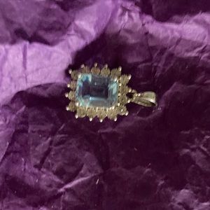 Blue topaz pendant. Surrounded with metal chips